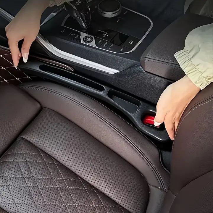 Car gap filler being fitted between seat and console